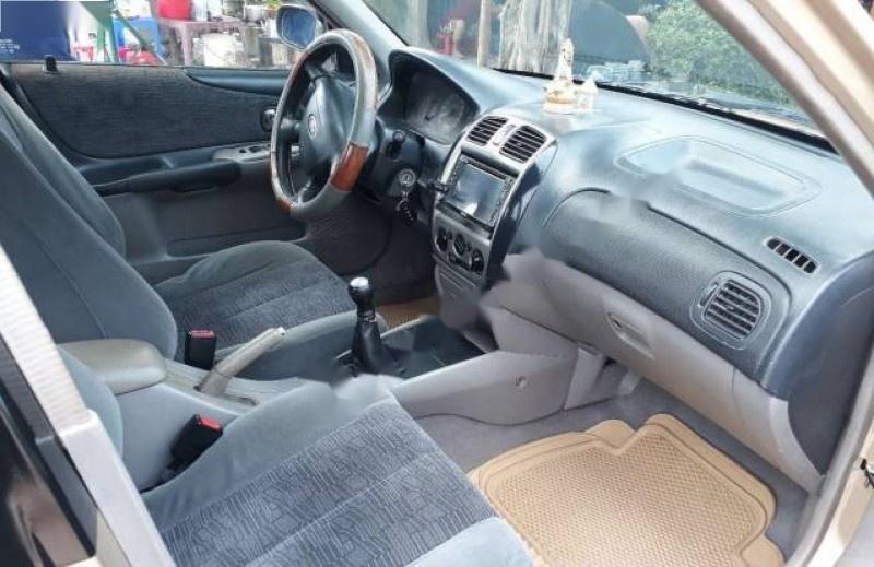 Ford Laser Delu 1.6 MT 2002 - Bán ô tô Ford Laser Delu 1.6 MT sản xuất năm 2002, màu vàng