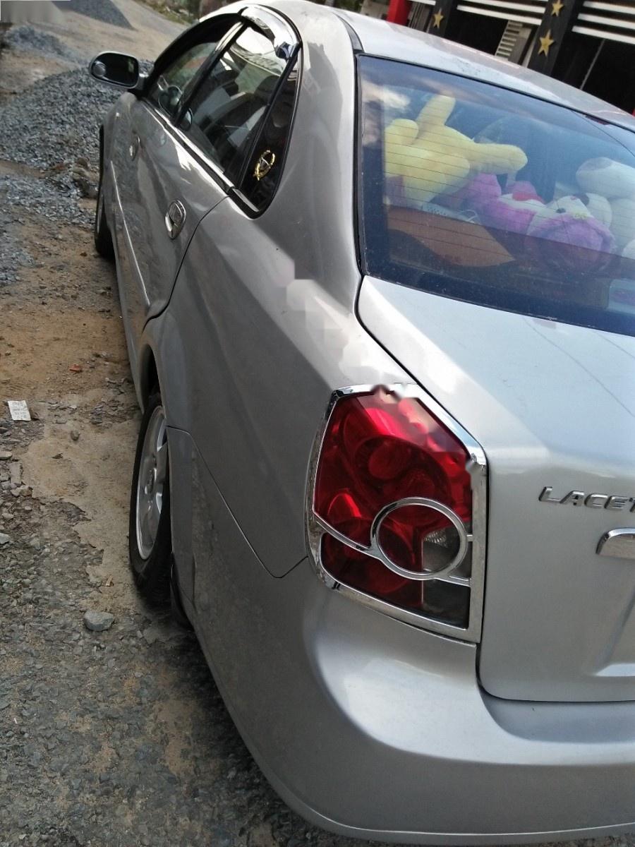 Daewoo Lacetti EX 1.6 MT 2005 - Cần bán gấp Daewoo Lacetti EX 1.6 MT năm sản xuất 2005, màu bạc