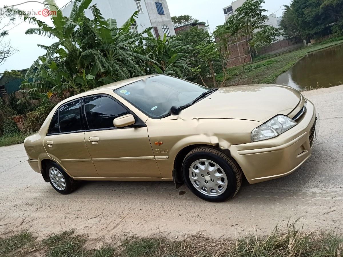 Ford Laser Delu 1.6 MT 2001 - Cần bán gấp Ford Laser MT đời 2001, màu vàng xe gia đình