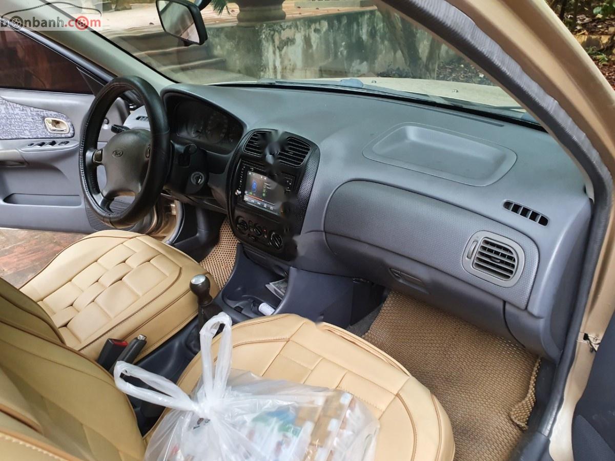 Ford Laser Delu 1.6 MT 2001 - Cần bán gấp Ford Laser MT đời 2001, màu vàng xe gia đình