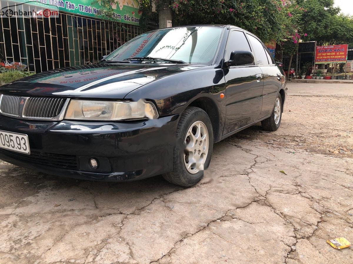 Mitsubishi Lancer GLXI 1.6 MT 2003 - Cần bán Mitsubishi Lancer GLXI 1.6 MT sản xuất 2003, màu xanh lam xe gia đình