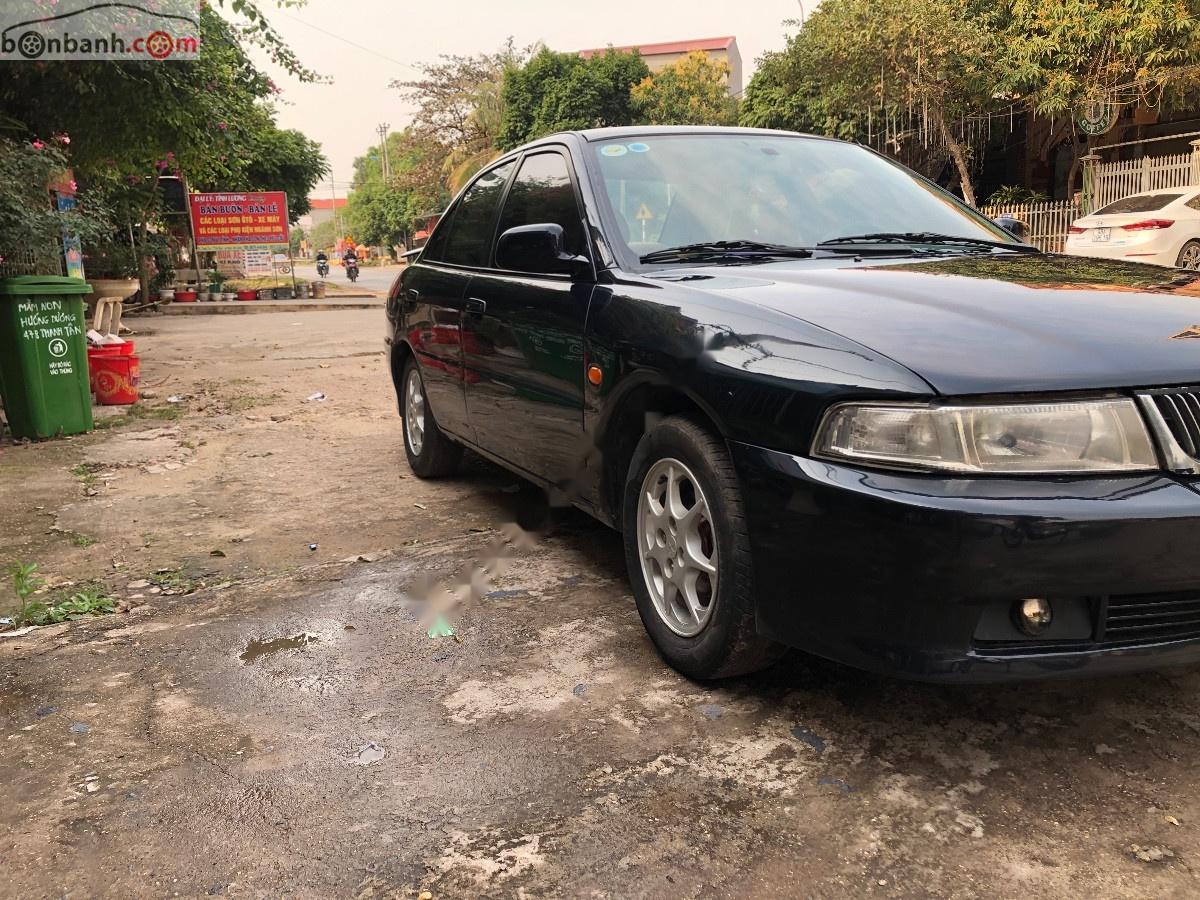 Mitsubishi Lancer GLXI 1.6 MT 2003 - Cần bán Mitsubishi Lancer GLXI 1.6 MT sản xuất 2003, màu xanh lam xe gia đình