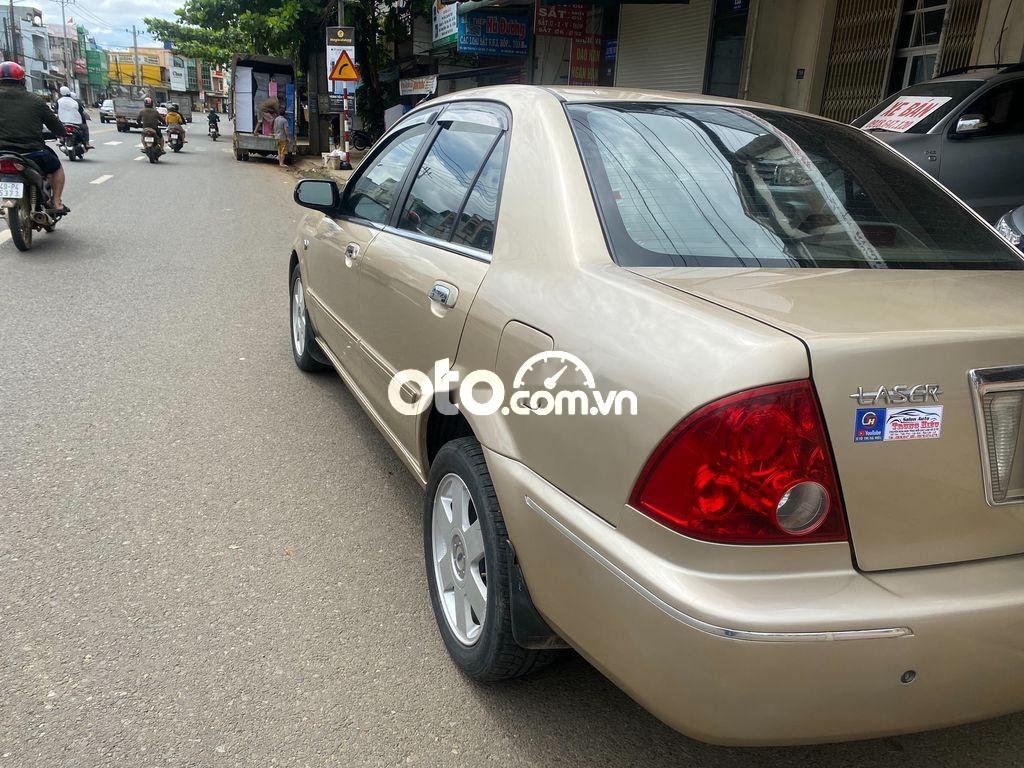 Ford Laser     2002 - Cần bán gấp Ford Laser đời 2002, màu vàng còn mới, giá 145tr