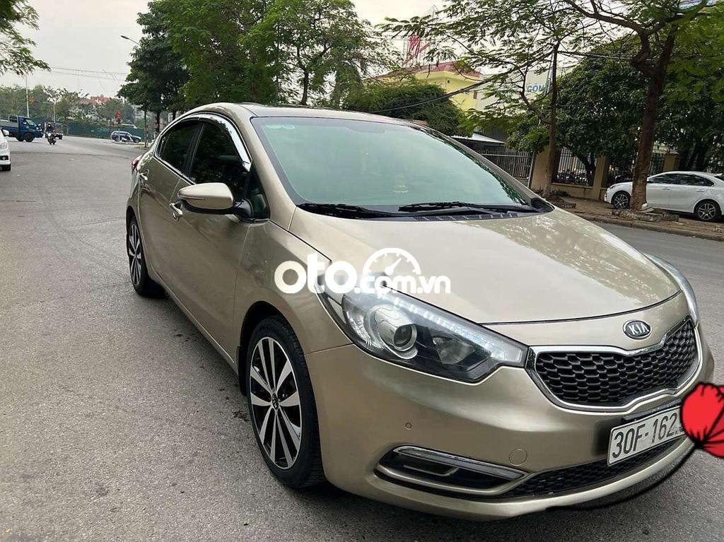 Kia K3   AT 2014 - Bán xe Kia K3 AT năm 2014, màu vàng cát, nhập khẩu