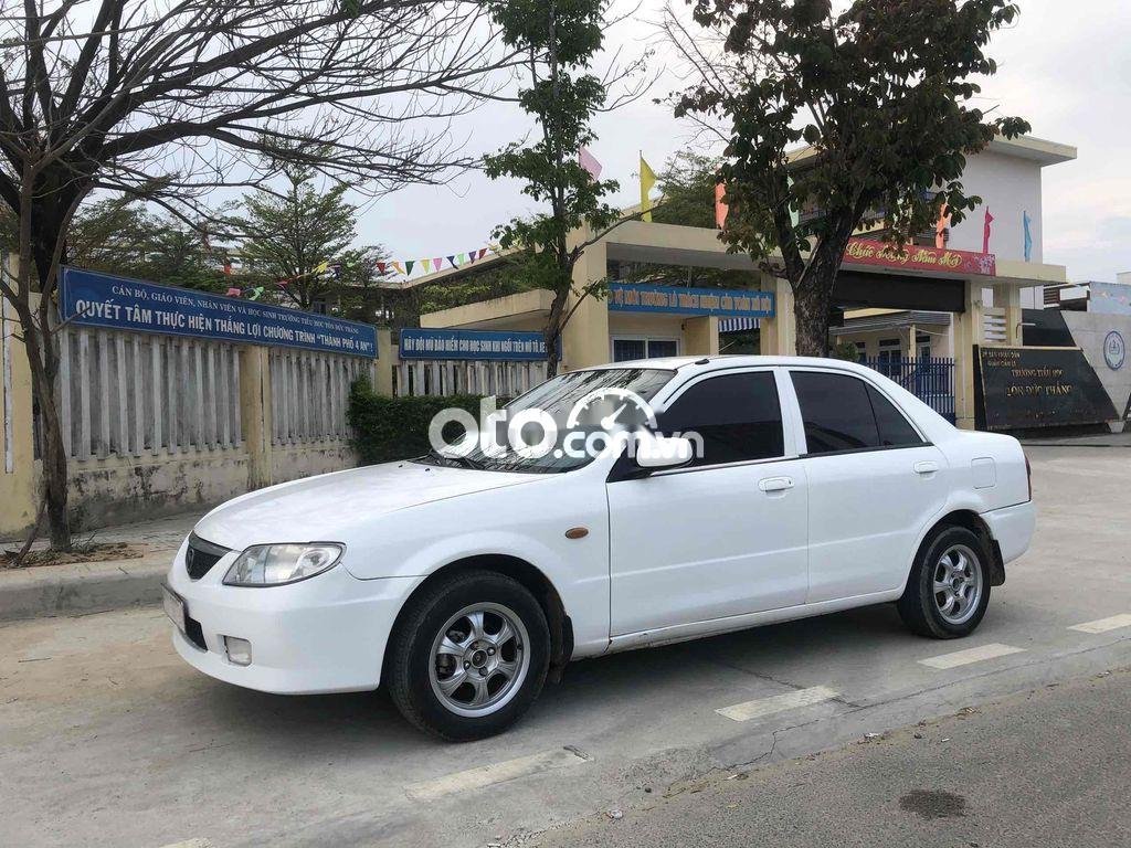 Mazda 323 2004 - Cần bán lại xe Mazda 323 sản xuất năm 2004, màu trắng