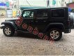 Jeep Wrangler Unlimited Sport 2010 - Cần bán gấp Jeep Wrangler Unlimited Sport 2010, màu đen, xe nhập chính chủ