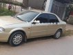 Ford Laser Delu 2001 - Cần bán xe Ford Laser Delu năm 2001, màu vàng