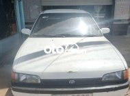 Bán ô tô Mazda 323 sản xuất 1995, màu trắng, nhập khẩu giá 30 triệu tại Sóc Trăng