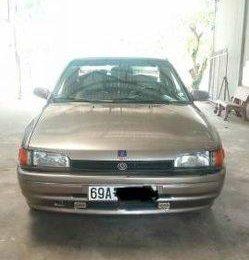 Mazda 323 1995 - Bán xe Mazda 323 đời 1995, màu vàng số sàn, 90 triệu