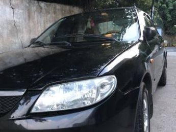 Mazda 323 2004 - Gia đình bán Mazda 323 2004, màu đen, 150tr