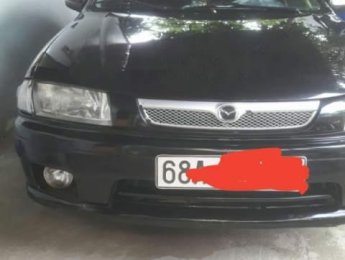 Mazda 323  MT 2000 - Cần bán gấp Mazda 323 MT năm sản xuất 2000, màu đen, xe nhà ít đi