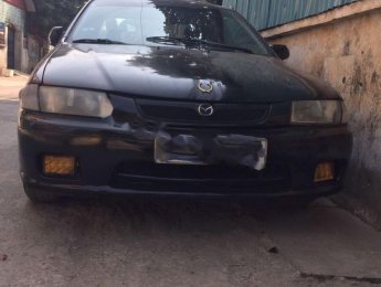 Mazda 323 1997 - Cần bán gấp Mazda 323 năm sản xuất 1997, màu đen, xe nhập chính hãng